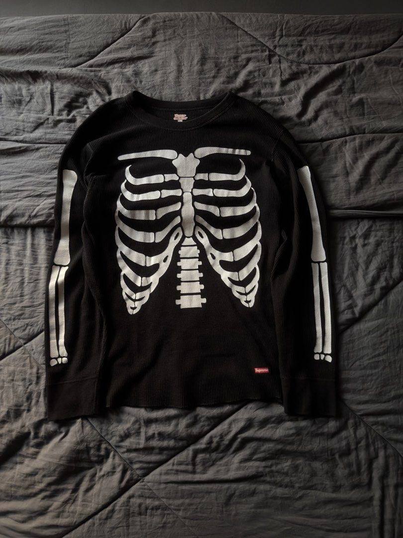 Supreme Skeleton Ribbed Long Sleeve Thermal Black (Category: Longsleeves) located in Cabanatuan. Submitted by archive.stuffz (Listing ID 1464984591, Image 3). Description: - Brand: Supreme - Item: Thermal Long Sleeve Top - Color: Black with white skeleton ribcage & arm graphics - Material: Classic waffle knit texture - Details: Red Supreme box logo near hem, ribbed crew neckline & cuffs - Condition: Great streetwear piece, ideal for cooler weathe