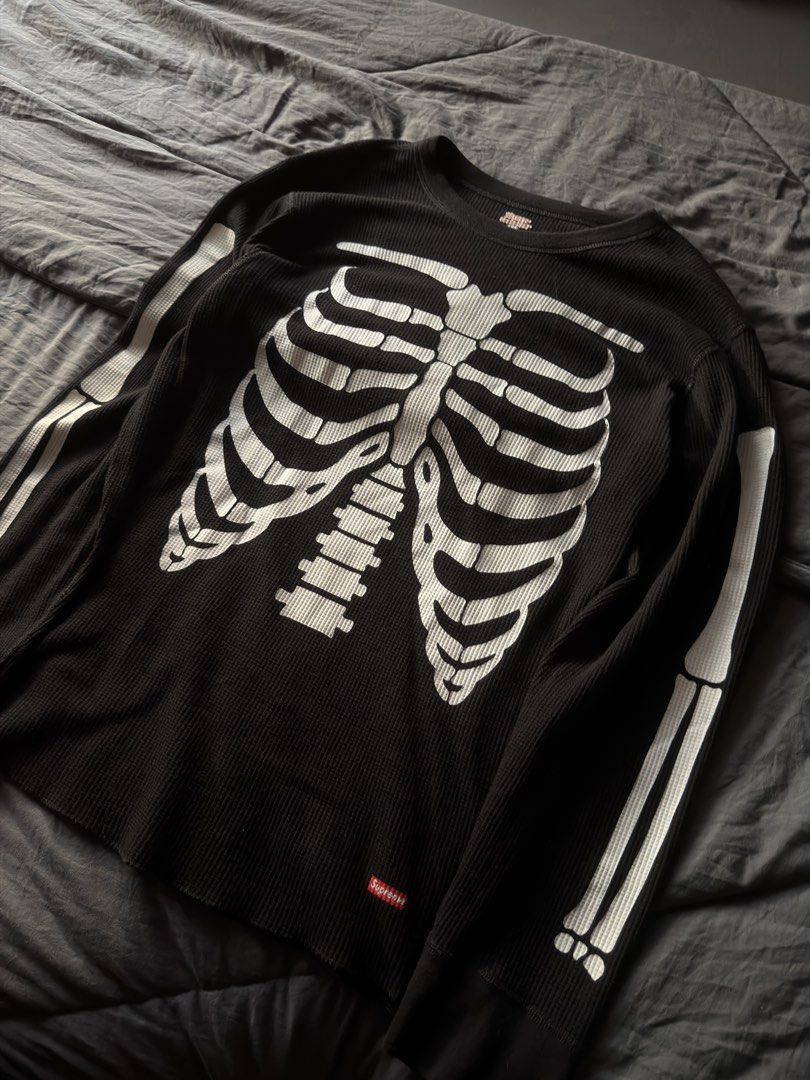 Supreme Skeleton Ribbed Long Sleeve Thermal Black (Category: Longsleeves) located in Cabanatuan. Submitted by archive.stuffz (Listing ID 1464984591, Image 2). Description: - Brand: Supreme - Item: Thermal Long Sleeve Top - Color: Black with white skeleton ribcage & arm graphics - Material: Classic waffle knit texture - Details: Red Supreme box logo near hem, ribbed crew neckline & cuffs - Condition: Great streetwear piece, ideal for cooler weathe