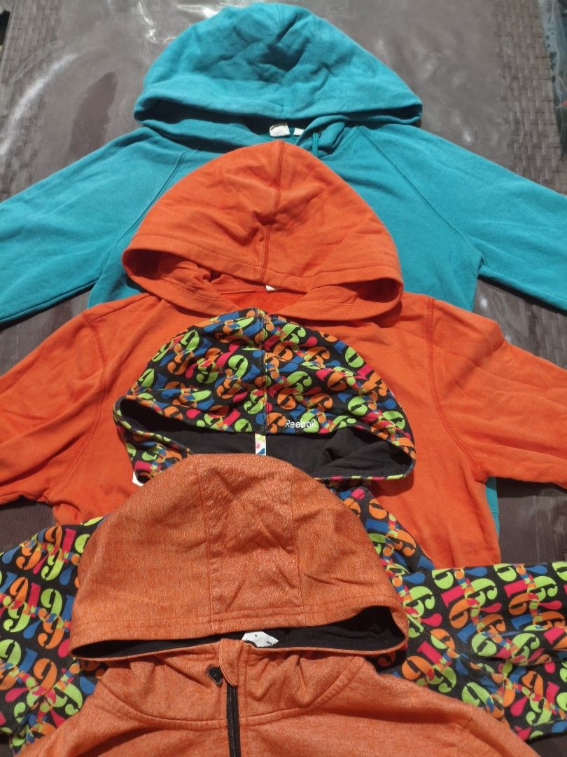 TAKE ALL 9-14 YEARS OLD (Category: Babies & Kids Fashion) located in Baguio. Submitted by zayneshop (Listing ID 1465053592, Image 1). Description: - Set of 4 zip-up hoodies in different colors and prints - Includes turquoise GAP logo, orange GAP logo, orange heather, and black with colorful graphic pattern - Features front zippers and attached hoods - Great casual everyday layering pieces - Perfect for men and women's casual wardrobe.