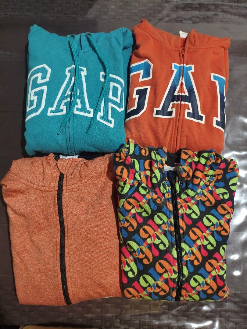 TAKE ALL 9-14 YEARS OLD (Category: Babies & Kids Fashion) located in Baguio. Submitted by zayneshop (Listing ID 1465053592, Image 2). Description: - Set of 4 zip-up hoodies in different colors and prints - Includes turquoise GAP logo, orange GAP logo, orange heather, and black with colorful graphic pattern - Features front zippers and attached hoods - Great casual everyday layering pieces - Perfect for men and women's casual wardrobe.