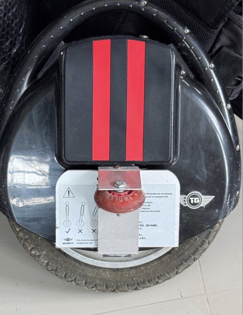 Teamgee Electric Unicycle with Charger (Category: Skates, Rollerblades & Scooters) located in Cavite. Submitted by marcuz1316 (Listing ID 1465158841, Image 2). Description: - Brand: Teamgee Electric Unicycle - Color: Black with stylish red stripes on the top cushion - Condition: Used, with visible scratches on the outer plastic body - Features: Includes convenient folding foot pedals and a small training wheel attached near the base (great for be