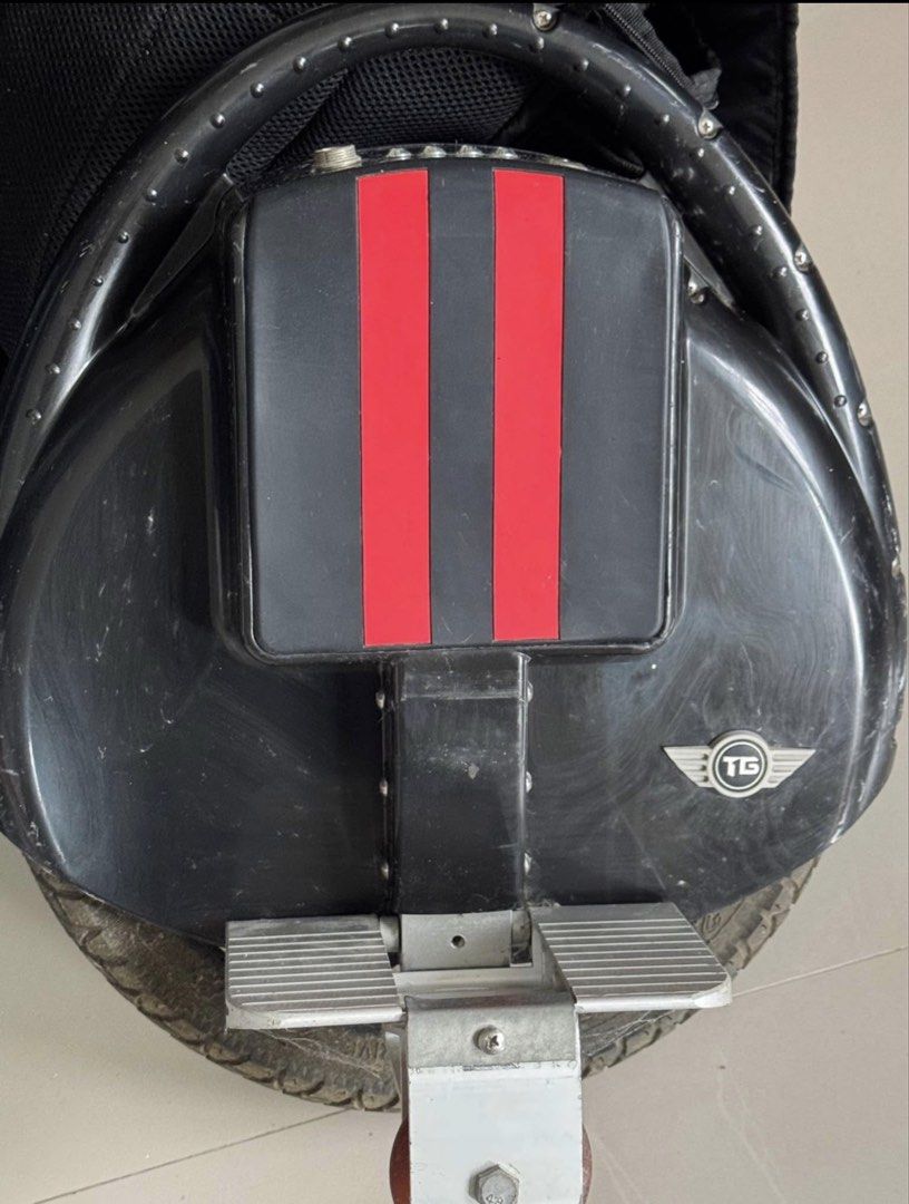 Teamgee Electric Unicycle with Charger (Category: Skates, Rollerblades & Scooters) located in Cavite. Submitted by marcuz1316 (Listing ID 1465158841, Image 1). Description: - Brand: Teamgee Electric Unicycle - Color: Black with stylish red stripes on the top cushion - Condition: Used, with visible scratches on the outer plastic body - Features: Includes convenient folding foot pedals and a small training wheel attached near the base (great for be