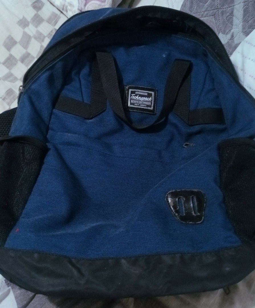 Technopack Blue Backpack with Black Base and Straps (Category: Backpacks) located in Manila. Submitted by japalopy406 (Listing ID 1465052253, Image 1). Description: - Brand: Technopack - Color: Blue with black base - Straps: Padded blue and black shoulder straps with top carry handles - Storage: Main zip compartment, front pocket, and dual mesh side pockets - Details: Authentic Craftsmanship front branding label - Ideal for: Daily commutes, schoo