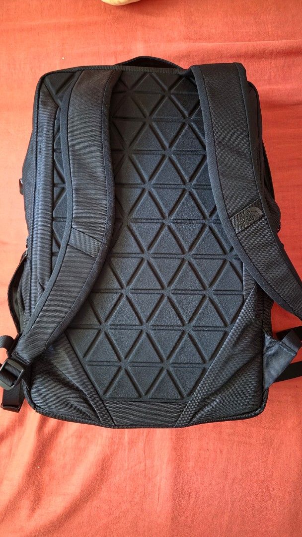 The North Face Black Backpack (Category: Backpacks) located in Caloocan City. Submitted by jmn_shop (Listing ID 1465030779, Image 2). Description: - Authentic The North Face backpack in versatile black - Clean exterior with tonal brand logo on the top right - Convenient front zipper pocket for quick-access items - Padded back panel featuring a geometric triangle pattern for airflow and comfort - Adjustable shoulder straps equipped with durable ha