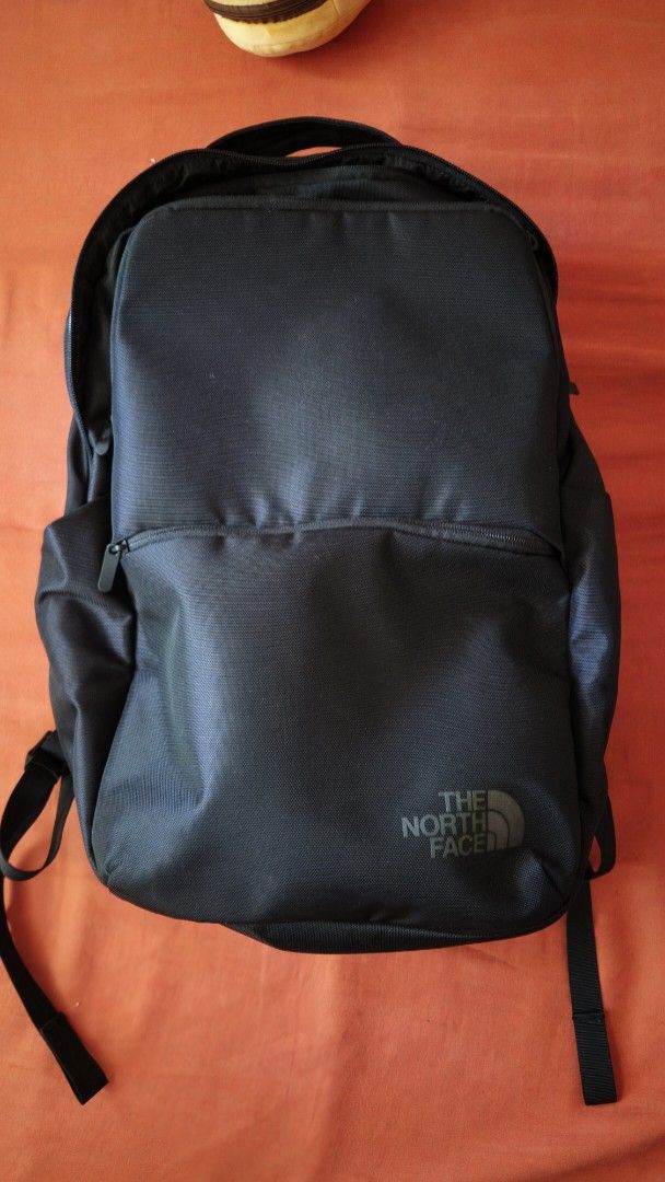 The North Face Black Backpack (Category: Backpacks) located in Caloocan City. Submitted by jmn_shop (Listing ID 1465030779, Image 1). Description: - Authentic The North Face backpack in versatile black - Clean exterior with tonal brand logo on the top right - Convenient front zipper pocket for quick-access items - Padded back panel featuring a geometric triangle pattern for airflow and comfort - Adjustable shoulder straps equipped with durable ha