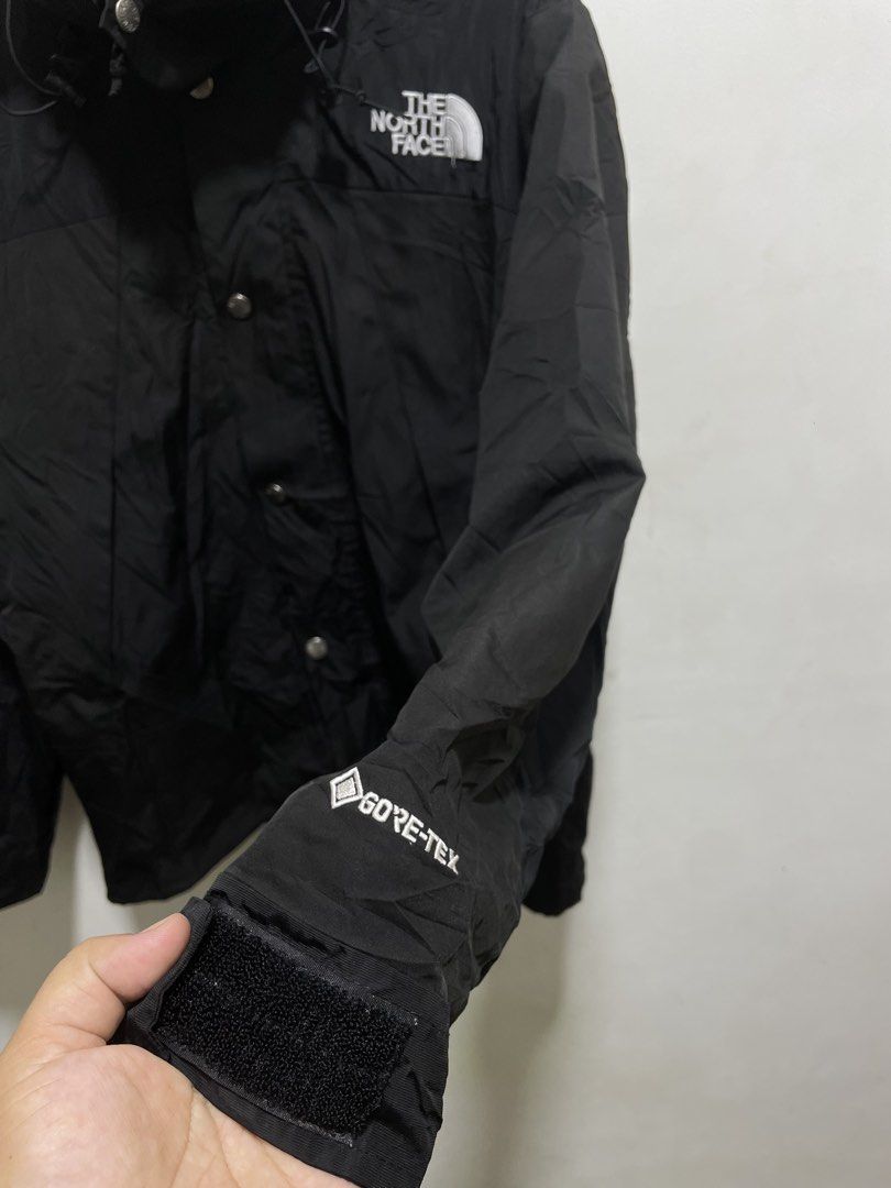 The North Face Black Gore-Tex Waterproof Jacket (Category: Coats, Jackets and Outerwear) located in Santiago. Submitted by UkayLuxxSelector (Listing ID 1465074164, Image 2). Description: - Brand: The North Face - Color: Solid black - Material: Waterproof Gore-Tex fabric - Hardware: YKK zippers with authenticity hologram patch - Closure: Full zip front with button storm flap - Fit: Standard fit - Features: Adjustable velcro cuffs, cinch cords at h