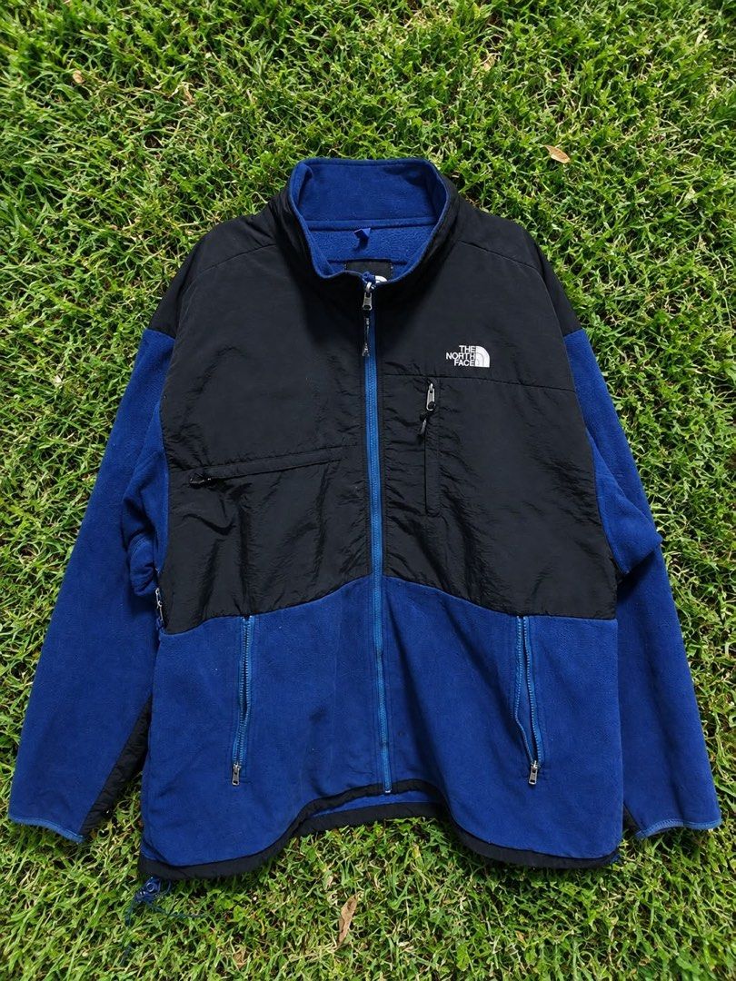 The North Face Blue Black Fleece Jacket (Category: Coats, Jackets and Outerwear) located in Manila. Submitted by zenfox_948652 (Listing ID 1465114228, Image 1). Description: - Brand: The North Face - Colorway: Blue and Black - Design: Full zip front with stand-up collar and nylon overlays on chest and shoulders - Pockets: Two zippered lower pockets and one zippered chest pocket - Details: Embroidered logo on upper chest - Condition: Excellent / R