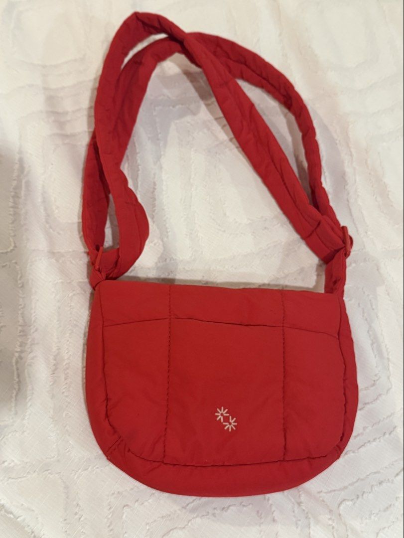 The Paper Bunny Small Quilted Bag - Red (Category: Shoulder Bags) located in Mandaluyong City. Submitted by lau.rn (Listing ID 1465055785, Image 3). Description: - Brand: The Paper Bunny - Color: Bright red - Material: Lightweight quilted fabric with interior lining - Closure: Secure zip closure - Strap: Adjustable for custom fit - Details: Cute embroidered star logo on the front pocket and brand label tag inside - Condition: Clean interior, high