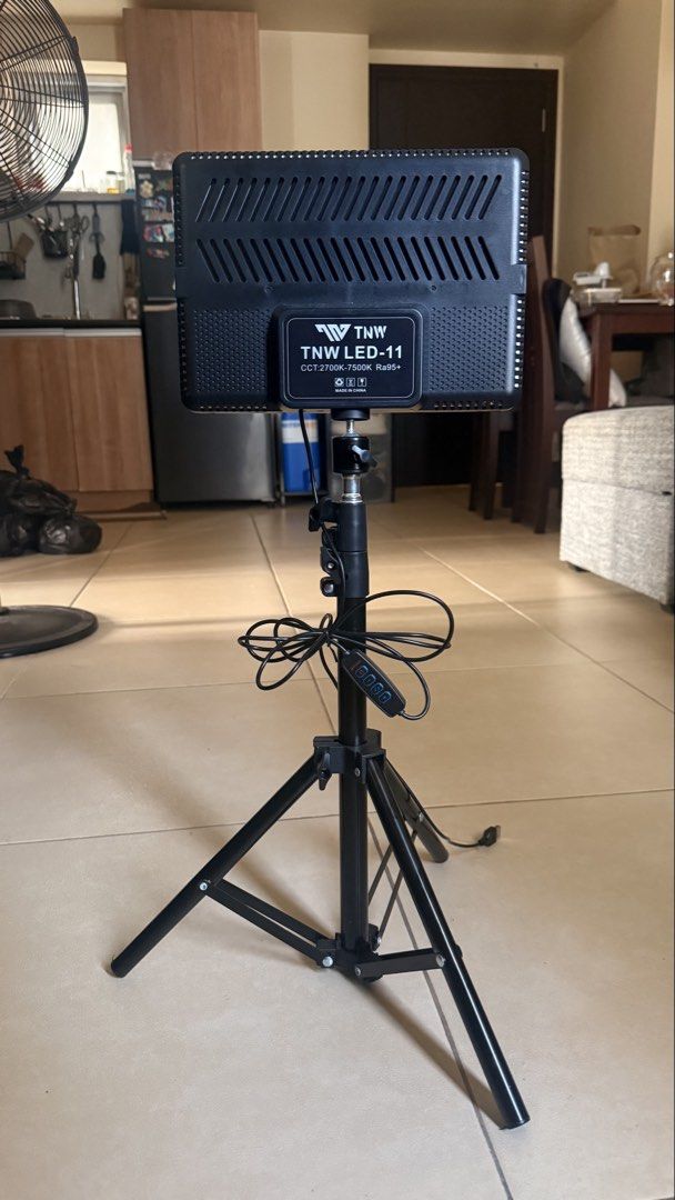 TNW LED-11 LED Panel Light with Tripod (Category: Lighting & Studio Equipment) located in Makati City. Submitted by chie_3030 (Listing ID 1465038880, Image 2). Description: - Model: TNW LED-11 Panel Light with adjustable tripod stand - Color Temperature: 2700K to 7500K for versatile lighting moods - Color Accuracy: Ra95+ rating for natural, vibrant skin tones - Easy Controls: In-line unit for power, brightness, and mode adjustments - Power Source
