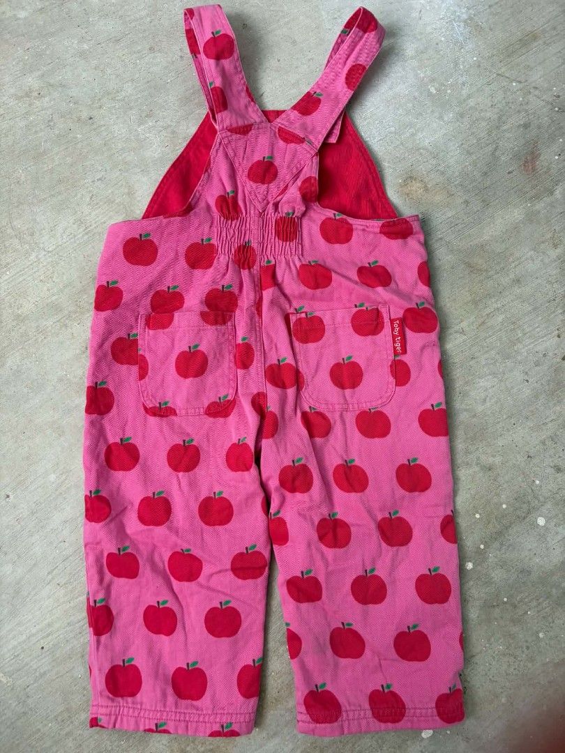 Toby Tiger Apple Print Pink Overalls (Category: Babies & Kids Fashion) located in Las Pinas. Submitted by pinkpototo36548 (Listing ID 1465071733, Image 2). Description: - Brand: Toby Tiger - Design: Pink overalls with all-over red apple print - Details: Red branded buttons on straps and sides - Pockets: Front chest pocket with red label tag and two back pockets - Style: Bright, playful, and comfortable for kids.