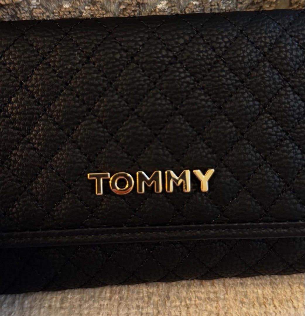 Tommy Hilfiger Black Quilted Wallet (Category: Wallets & Card holders) located in Manila. Submitted by luwiswisz (Listing ID 1465052520, Image 3). Description: - Brand: Tommy Hilfiger - Color: Classic Black with chic gold hardware - Material/Design: Quilted design with snap button closure - Interior: Multiple card slots, clear ID window, and spacious cash compartments - Extra Storage: Convenient zippered coin pocket along the top edge - Condition