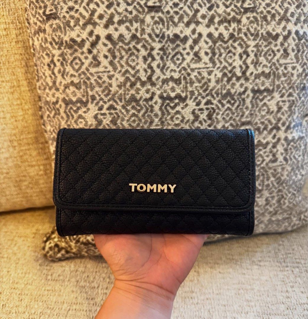 Tommy Hilfiger Black Quilted Wallet (Category: Wallets & Card holders) located in Manila. Submitted by luwiswisz (Listing ID 1465052520, Image 2). Description: - Brand: Tommy Hilfiger - Color: Classic Black with chic gold hardware - Material/Design: Quilted design with snap button closure - Interior: Multiple card slots, clear ID window, and spacious cash compartments - Extra Storage: Convenient zippered coin pocket along the top edge - Condition
