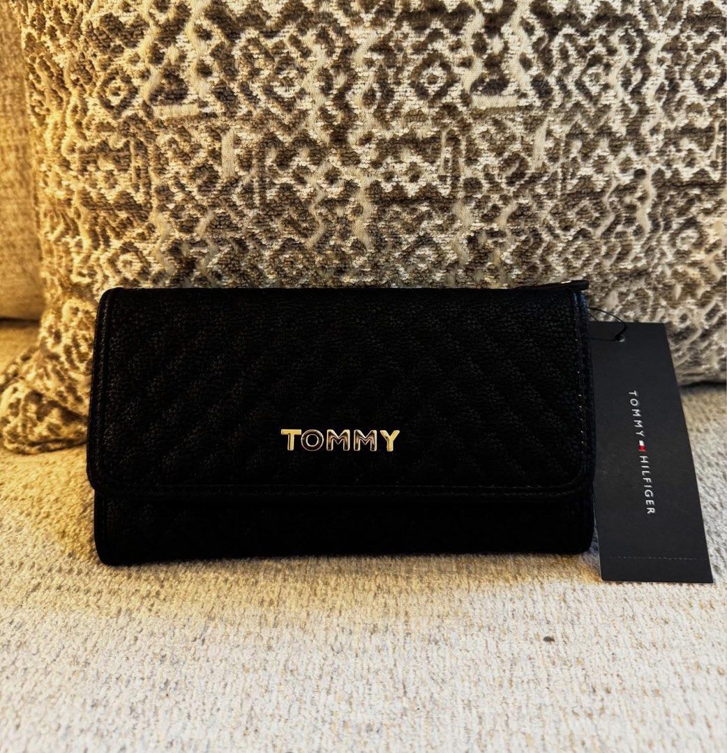 Tommy Hilfiger Black Quilted Wallet (Category: Wallets & Card holders) located in Manila. Submitted by luwiswisz (Listing ID 1465052520, Image 1). Description: - Brand: Tommy Hilfiger - Color: Classic Black with chic gold hardware - Material/Design: Quilted design with snap button closure - Interior: Multiple card slots, clear ID window, and spacious cash compartments - Extra Storage: Convenient zippered coin pocket along the top edge - Condition