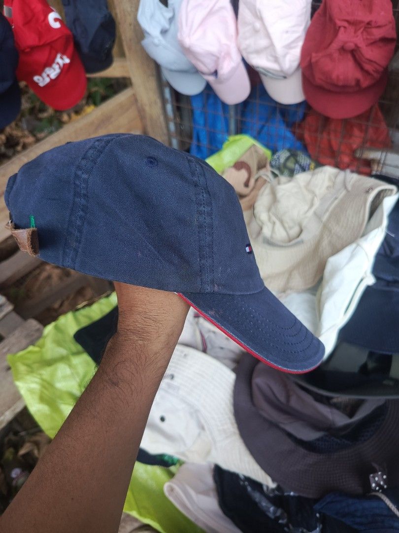 Tommy Hilfiger Navy Blue Baseball Cap (Category: Caps & Hats) located in City of Isabela. Submitted by warmbird.d06e6f (Listing ID 1465064207, Image 3). Description: - Brand: Tommy Hilfiger - Color: Navy Blue - Size: One size fits all (adjustable) - Details: Embroidered front logo, blue & white striped inner lining - Strap: Brown leather strapback with metal buckle - Condition: Excellent / Brand New - Style: Classic everyday accessory.