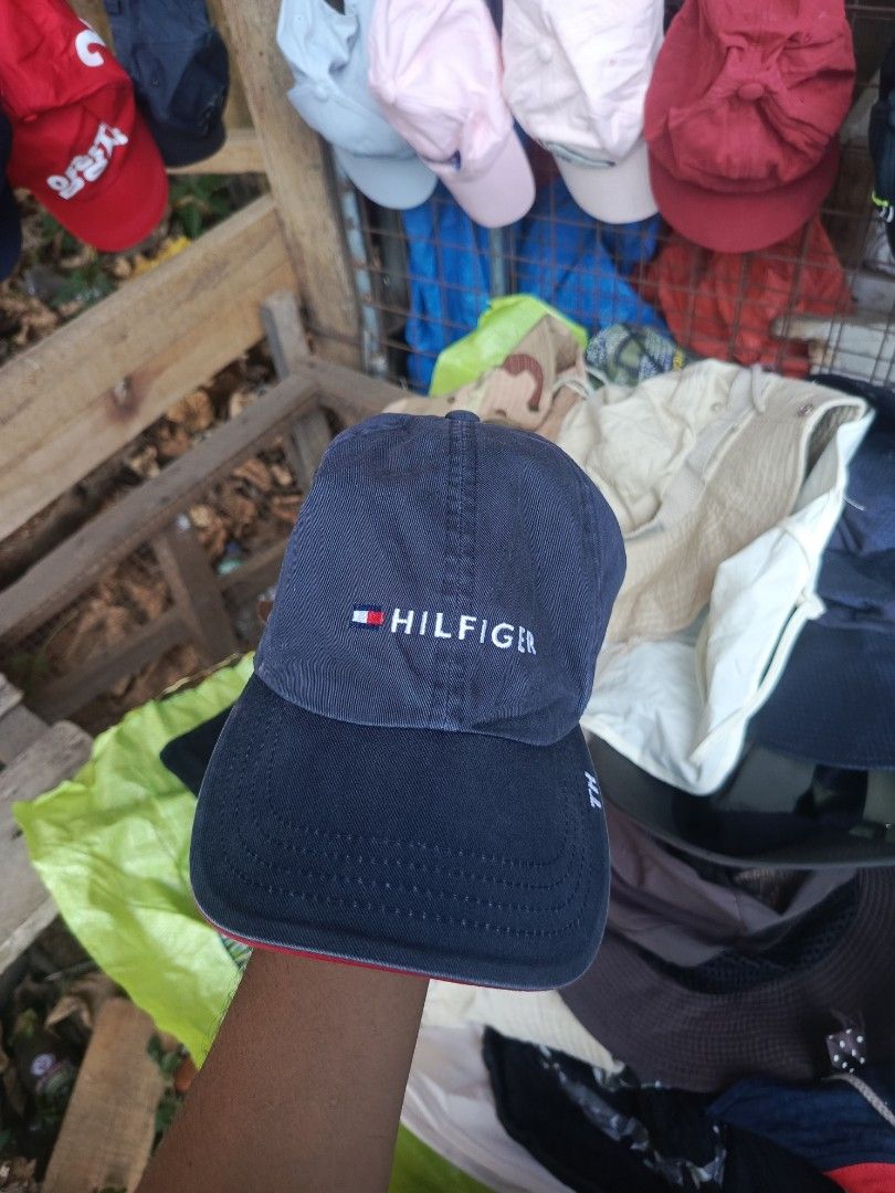Tommy Hilfiger Navy Blue Baseball Cap (Category: Caps & Hats) located in City of Isabela. Submitted by warmbird.d06e6f (Listing ID 1465064207, Image 1). Description: - Brand: Tommy Hilfiger - Color: Navy Blue - Size: One size fits all (adjustable) - Details: Embroidered front logo, blue & white striped inner lining - Strap: Brown leather strapback with metal buckle - Condition: Excellent / Brand New - Style: Classic everyday accessory.