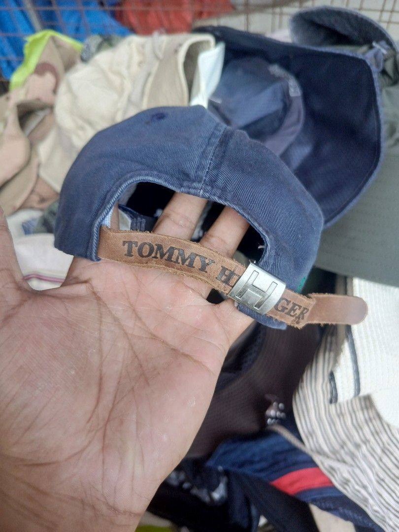 Tommy Hilfiger Navy Blue Baseball Cap (Category: Caps & Hats) located in City of Isabela. Submitted by warmbird.d06e6f (Listing ID 1465064207, Image 2). Description: - Brand: Tommy Hilfiger - Color: Navy Blue - Size: One size fits all (adjustable) - Details: Embroidered front logo, blue & white striped inner lining - Strap: Brown leather strapback with metal buckle - Condition: Excellent / Brand New - Style: Classic everyday accessory.