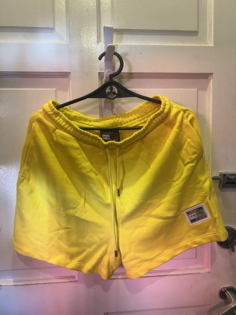 Tommy Hilfiger Yellow Sweatshorts (Category: Shorts) located in Manila. Submitted by cleverstone_21f597 (Listing ID 1464974642, Image 1). Description: - Brand: Tommy Hilfiger - Color: Bright yellow - Material: Soft, comfortable cotton - Features: Adjustable drawstring waistband, convenient side pockets, and small logo patch near the hem - Condition: Clean overall, no stains or flaws - Best for: Lounging or casual everyday wear.