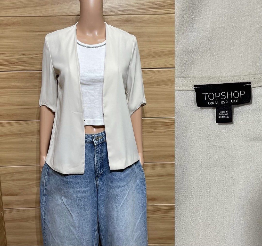 Topshop Cream Open Front Blazer Jacket (Category: Coats, Jackets and Outerwear) located in Malabon City. Submitted by annshopable_ (Listing ID 1465056226, Image 1). Description: - Brand: Topshop - Style: Open front blazer with short sleeves and raw hem - Color: Cream - Size: UK 6 / US 2 / EUR 34 - Material: Lightweight fabric - Condition: Clean, excellent, no flaws noticed - Made in: Sri Lanka.
