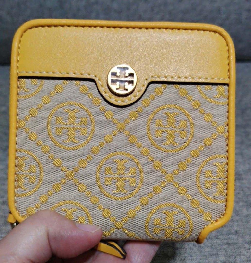 Tory Burch Monogram Zip Around Wallet Yellow Maroon (Category: Wallets & Card holders) located in Caloocan City. Submitted by tweetyferrer (Listing ID 1464993191, Image 1). Description: - Authentic Tory Burch wallet - Yellow and beige monogram print with bright yellow leather trim - Rich maroon leather interior with card slots and snap coin pocket - Gold Tory Burch logo stamped inside - Secure zip-around closure - Compact size, perfect for small 