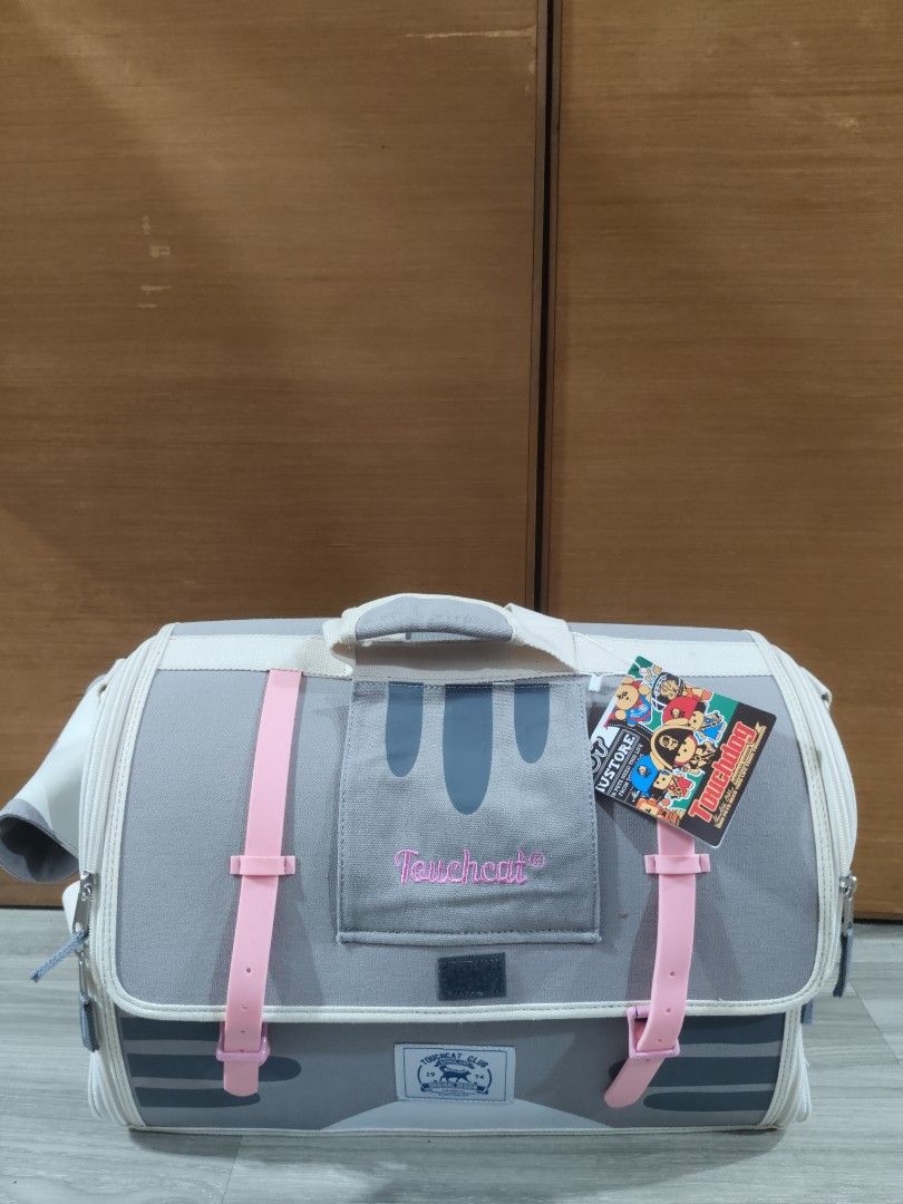 Touchcat Pet Carrier 18 Inch Gray (Category: Luggage) located in San Mateo. Submitted by roxyj120919 (Listing ID 1465158153, Image 2). Description: - Brand: Touchcat - Condition: Brand new with tag attached (never used) - Size: 18-inch - Color: Gray with cute pink straps - Ventilation: Mesh windows on sides and top flap - Details: Adorable cat paw prints on backpack straps and front logo patch.
