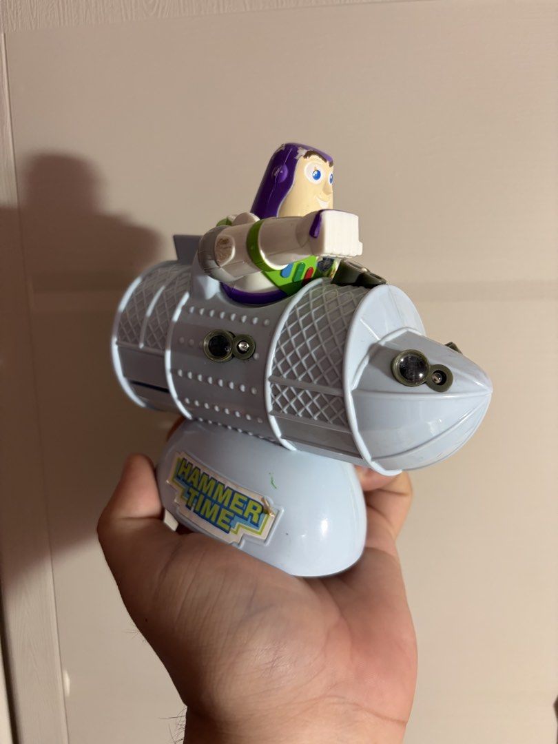 Toy Story Buzz Lightyear Rocket Ship Figure (Category: Figurines & Statues) located in Plaridel. Submitted by moddedjarvis (Listing ID 1465170087, Image 1). Description: - Character: Buzz Lightyear sitting on a blue rocket ship projector toy - Unique Details: Includes a 'Hammer Time' sticker on the base, lens details on the body, and a warning sticker on the back - Condition: Pre-loved, great display piece - Perfect For: Toy Story fans, kids, and