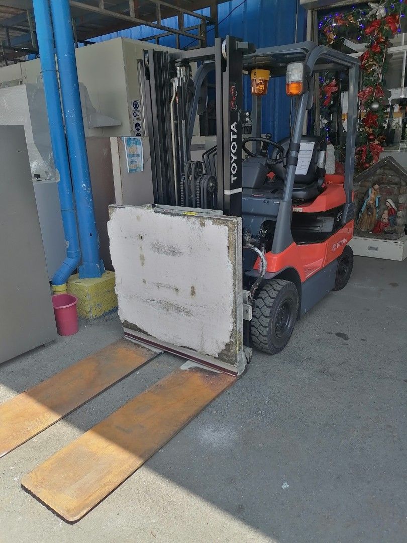 Toyota 1.5 Ton Forklift with Push-Pull Attachment (Category: Construction Tools & Equipment) located in Muntinlupa City. Submitted by fast_bryantorrentefernand (Listing ID 1464995307, Image 1). Description: NOW 350,000 WAS 500,000 - Brand/Model: Toyota Model 15 Forklift - Color: Bright orange and dark grey - Attachment: Push-pull slip-sheet attachment with long metal forks - Safety: Amber warning beacon light on overhead guard - Tires: Solid tire