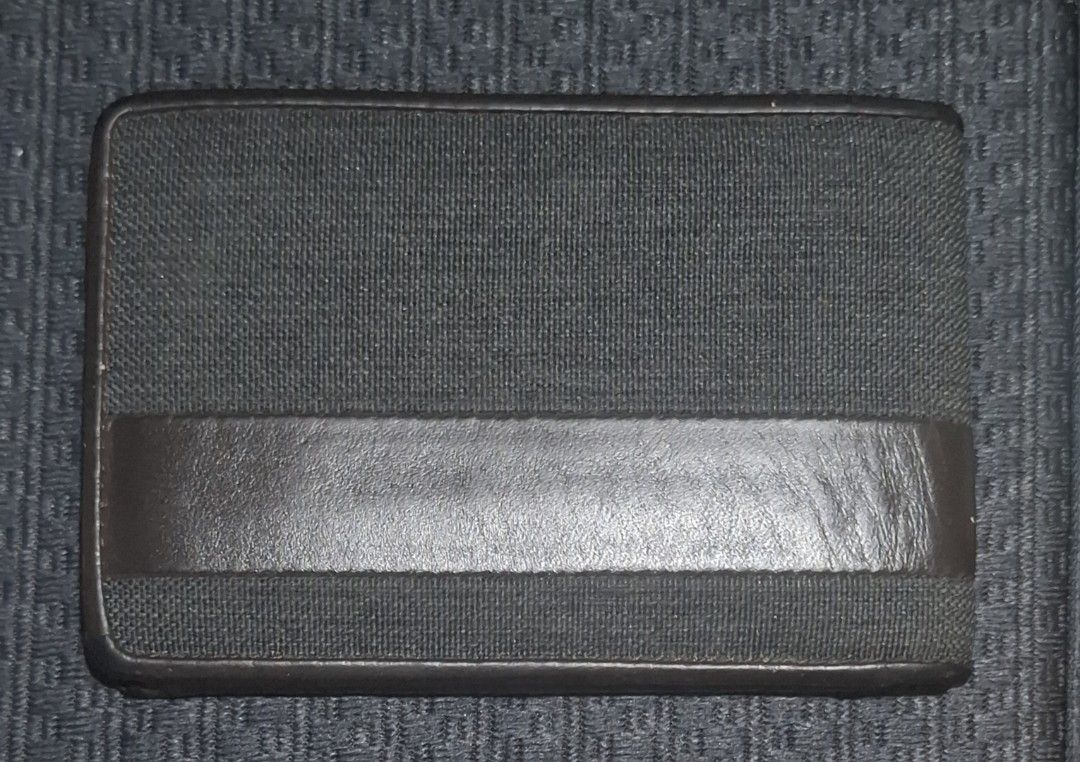 Tumi Brown Leather and Canvas Bifold Wallet (Category: Wallets & Card Holders) located in Makati City. Submitted by decluttermp (Listing ID 1464984735, Image 2). Description: - Authentic TUMI bifold wallet - Dark brown leather and durable textured fabric - Features front stripe with metal TUMI logo - Multiple card slots and full-length cash compartment - Compact size fits easily in back pockets - Clean interior and exterior stitching - Excellent 