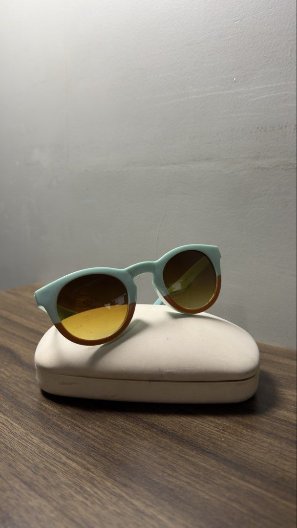 Two-tone pastel mint and orange round sunglasses (Category: Sunglasses & Eyewear) located in Baguio. Submitted by fndrskprskid (Listing ID 1465125313, Image 2). Description: - Style: Trendy round frame sunglasses in pastel mint green with bright orange bottom rims - Lenses: Gradient tinted for great shade and sun protection - Inclusions: Free white protective hardshell case - Vibe: Statement piece guaranteed to make you stand out!.