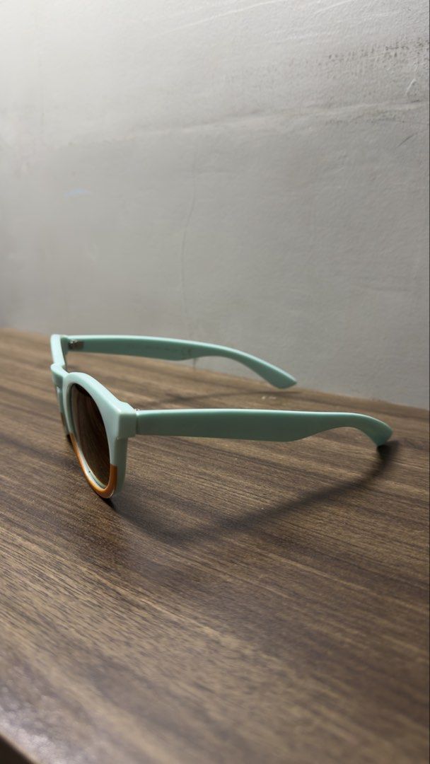 Two-tone pastel mint and orange round sunglasses (Category: Sunglasses & Eyewear) located in Baguio. Submitted by fndrskprskid (Listing ID 1465125313, Image 3). Description: - Style: Trendy round frame sunglasses in pastel mint green with bright orange bottom rims - Lenses: Gradient tinted for great shade and sun protection - Inclusions: Free white protective hardshell case - Vibe: Statement piece guaranteed to make you stand out!.
