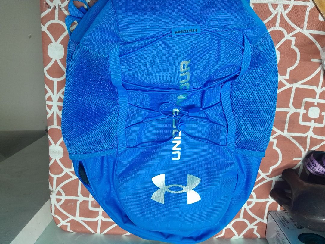 Under Armour Blue Backpack with Bungee Cords (Category: Backpacks) located in Bontoc. Submitted by younghustler101 (Listing ID 1465074050, Image 2). Description: - Brand: Under Armour - Color: Bright blue with a solid black back panel - Storage: Handy front elastic bungee cord system and mesh side pockets for water bottles - Comfort: Comfortable padded shoulder straps - Use: Durable everyday bag ideal for school, gym, or casual use.