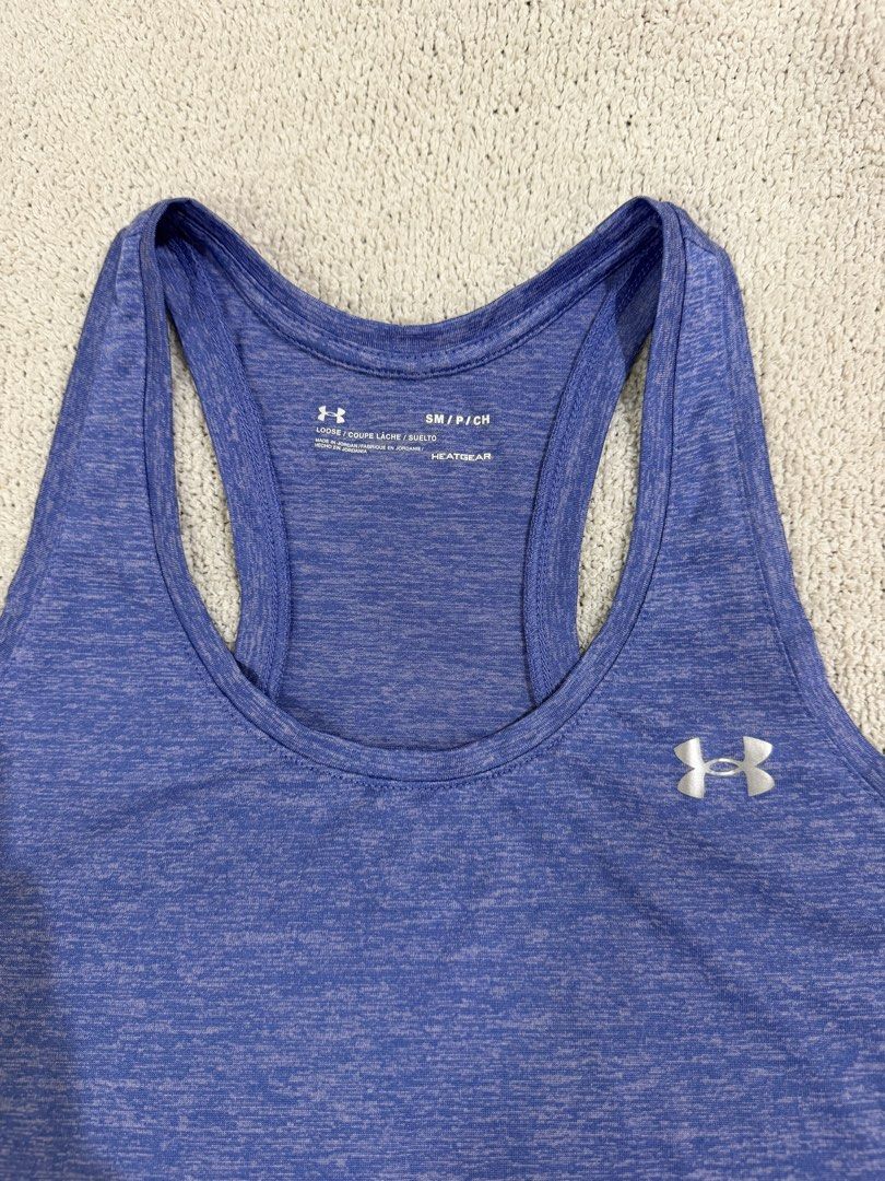 Under Armour Running Top S (Category: Activewear) located in Subic. Submitted by kittysclosetsale (Listing ID 1465007269, Image 2). Description: - Brand: Under Armour - Color: Heather Blue - Size: Small (Loose Fit) - Material: HeatGear fabric (ideal for workouts & training) - Design: Racerback with silver UA logos on chest and upper back - Condition: Clean, tagless printed collar.