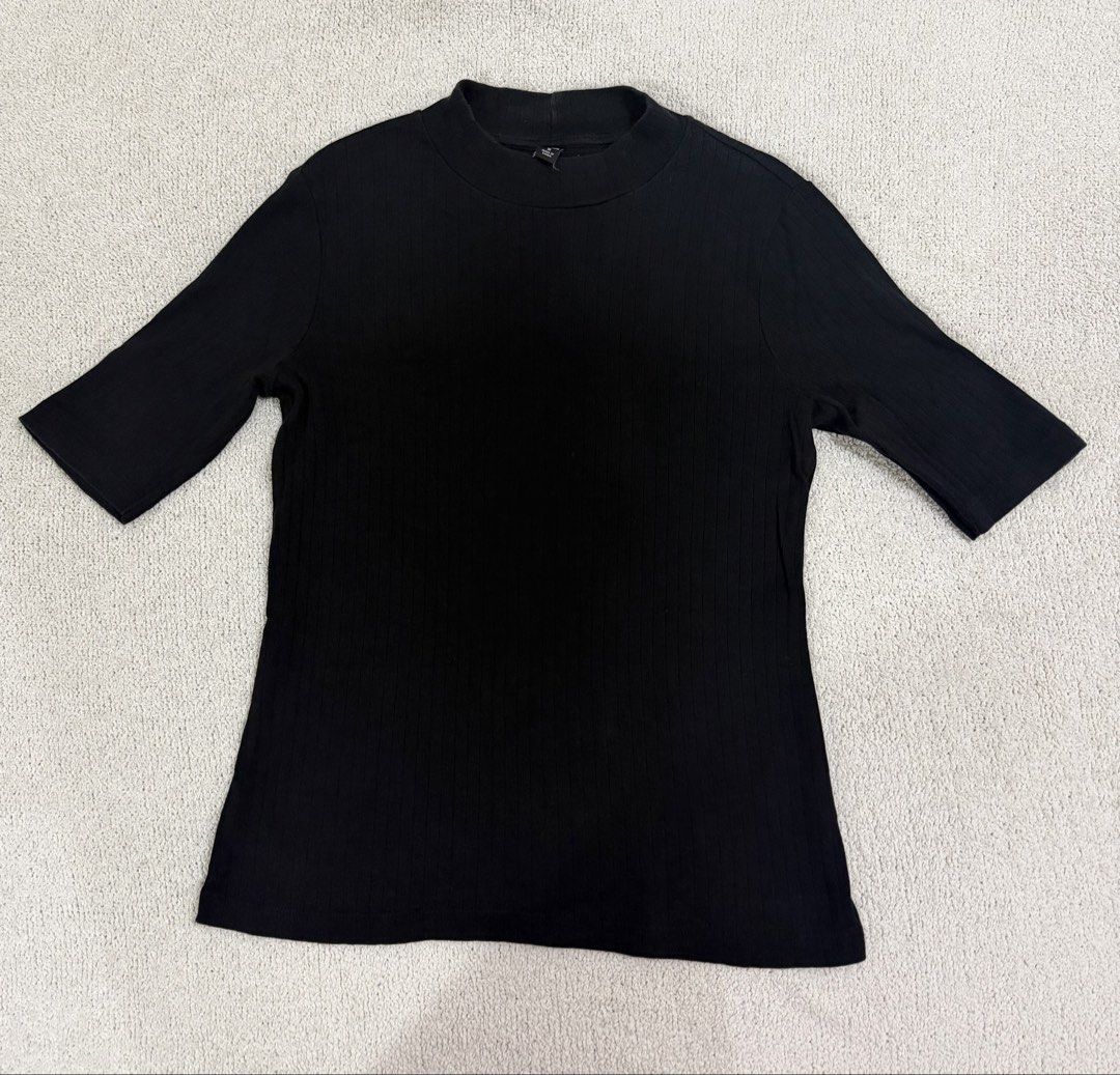 Uniqlo Black Ribbed Top M (Category: Shirts) located in Subic. Submitted by kittysclosetsale (Listing ID 1465093103, Image 1). Description: - Brand: Uniqlo - Color: Classic Black - Size: Medium - Material: Comfortable stretch fabric with vertical ribbing - Design: Mock neck, short sleeves - Style: Versatile basic piece for everyday wear.