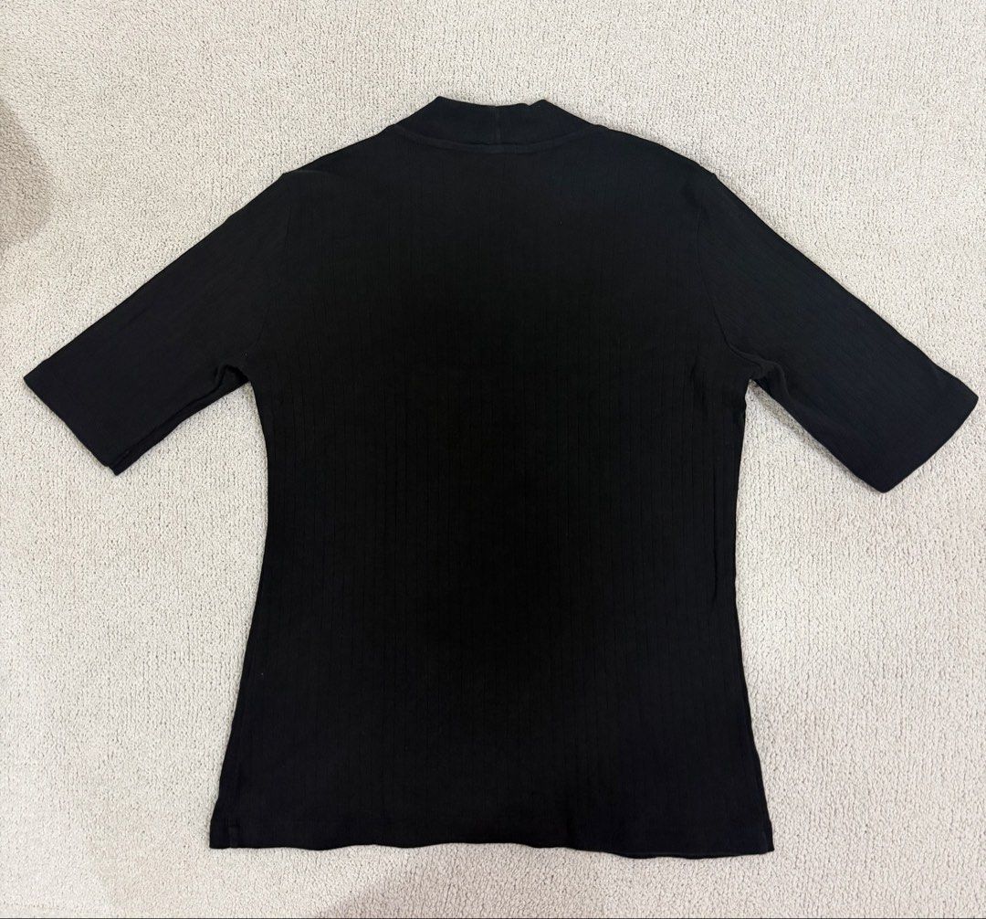 Uniqlo Black Ribbed Top M (Category: Shirts) located in Subic. Submitted by kittysclosetsale (Listing ID 1465093103, Image 2). Description: - Brand: Uniqlo - Color: Classic Black - Size: Medium - Material: Comfortable stretch fabric with vertical ribbing - Design: Mock neck, short sleeves - Style: Versatile basic piece for everyday wear.