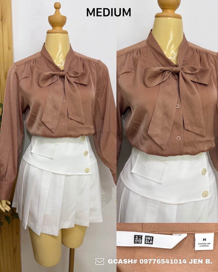 Uniqlo Brown Bow Tie Blouse Medium (Category: Blouses) located in Tagum. Submitted by bernardino49694 (Listing ID 1465005499, Image 1). Description: - Brand: Uniqlo - Size: Medium - Color: Brown (Neutral tone) - Material: Smooth, silky fabric - Origin: Made in China - Features: Button-down front with built-in neck bow tie detail - Styling: Easily matches with skirts or trousers.