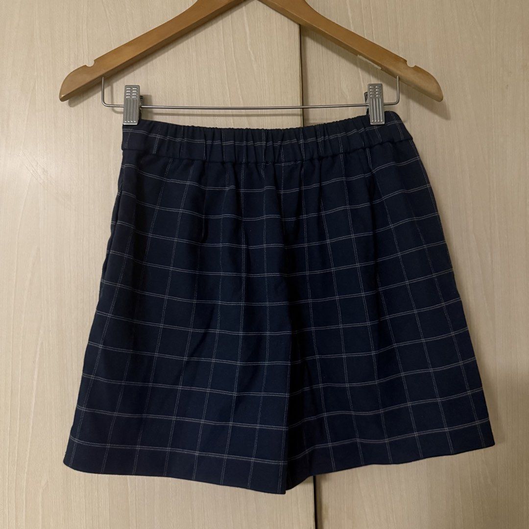 Uniqlo Navy Check Skort Size S (Category: Skirts) located in Quezon City. Submitted by pattb (Listing ID 1464971039, Image 2). Description: - Brand: Uniqlo - Style: Dark blue plaid skort (wrap skirt look in front, shorts underneath in back) - Size: S - Material: 64% polyester, 34% rayon, 2% spandex (with stretch) - Waist: 60-66cm (with elastic waistband) - Hips: 85-91cm - Details: Front button accent, Made in China - Condition: Excellent.