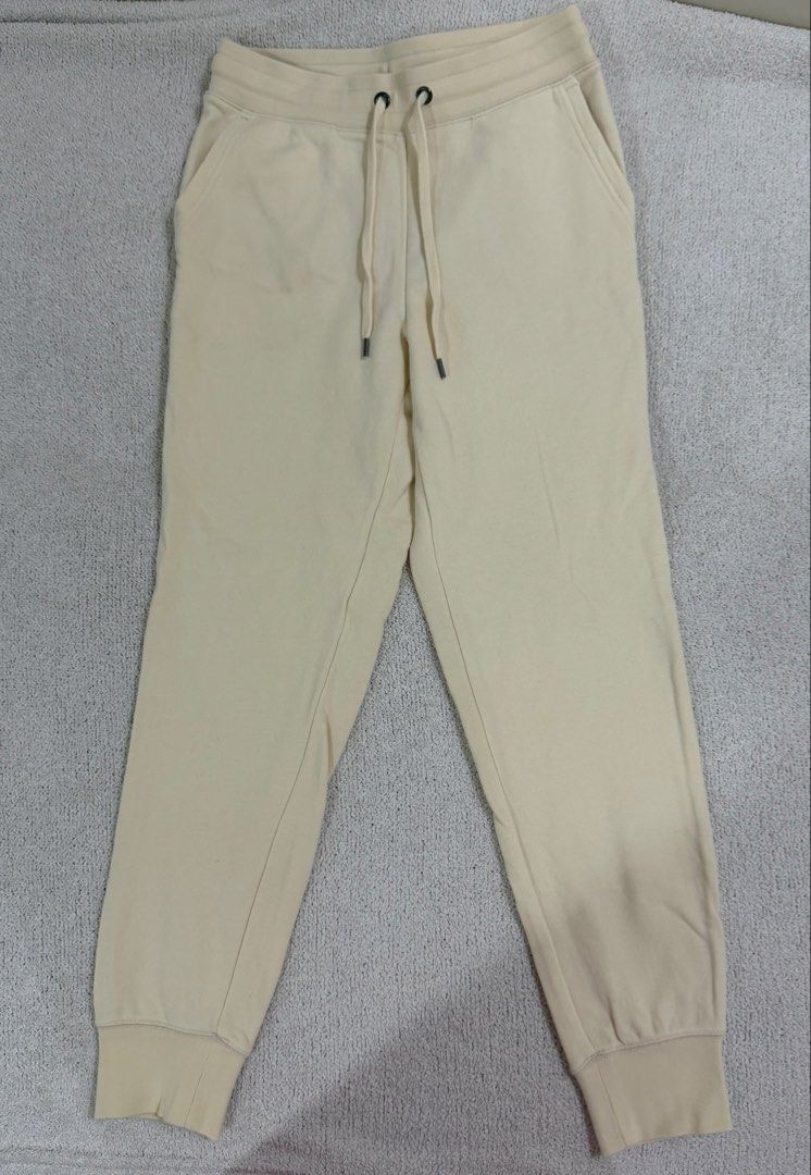Uniqlo Sweatpants Joggers Size S (Category: Other Bottoms) located in Subic. Submitted by kittysclosetsale (Listing ID 1465016489, Image 1). Description: - Brand: Uniqlo - Item: Cream Joggers / Sweatpants - Size: S (Waist: 60-66cm, Height: 155/62A) - Material: Body: 86% Cotton, 14% Polyester | Ribbing: 82% Cotton, 18% Polyester - Made in: Indonesia - Features: Drawstring waistband with metal tips, two side pockets, and ribbed ankle cuffs.