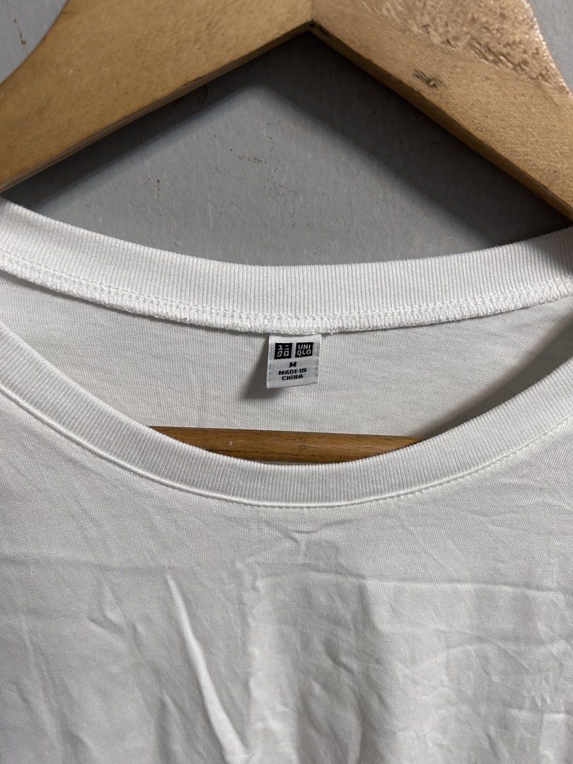 Uniqlo White Tank Top Size M (Category: Sleeveless) located in General Trias. Submitted by theosellye (Listing ID 1465170570, Image 2). Description: - Brand: Uniqlo - Size: M - Color: Solid White - Material: 100% cotton body, cotton-polyester blend ribbing - Design: Classic crew neckline, sleeveless, minimalist style - Condition: Brand new with tag attached - Origin: Made in China - Versatile basic, easy to mix and match with any outfit.