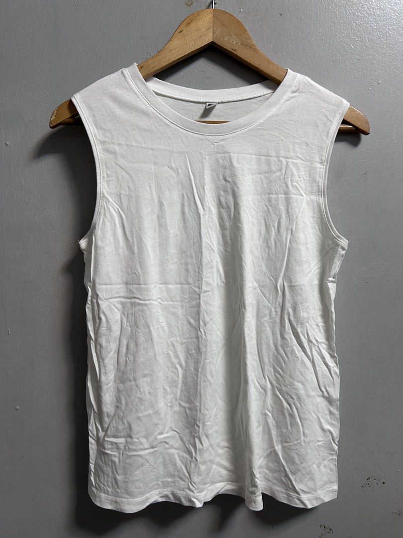 Uniqlo White Tank Top Size M (Category: Sleeveless) located in General Trias. Submitted by theosellye (Listing ID 1465170570, Image 1). Description: - Brand: Uniqlo - Size: M - Color: Solid White - Material: 100% cotton body, cotton-polyester blend ribbing - Design: Classic crew neckline, sleeveless, minimalist style - Condition: Brand new with tag attached - Origin: Made in China - Versatile basic, easy to mix and match with any outfit.