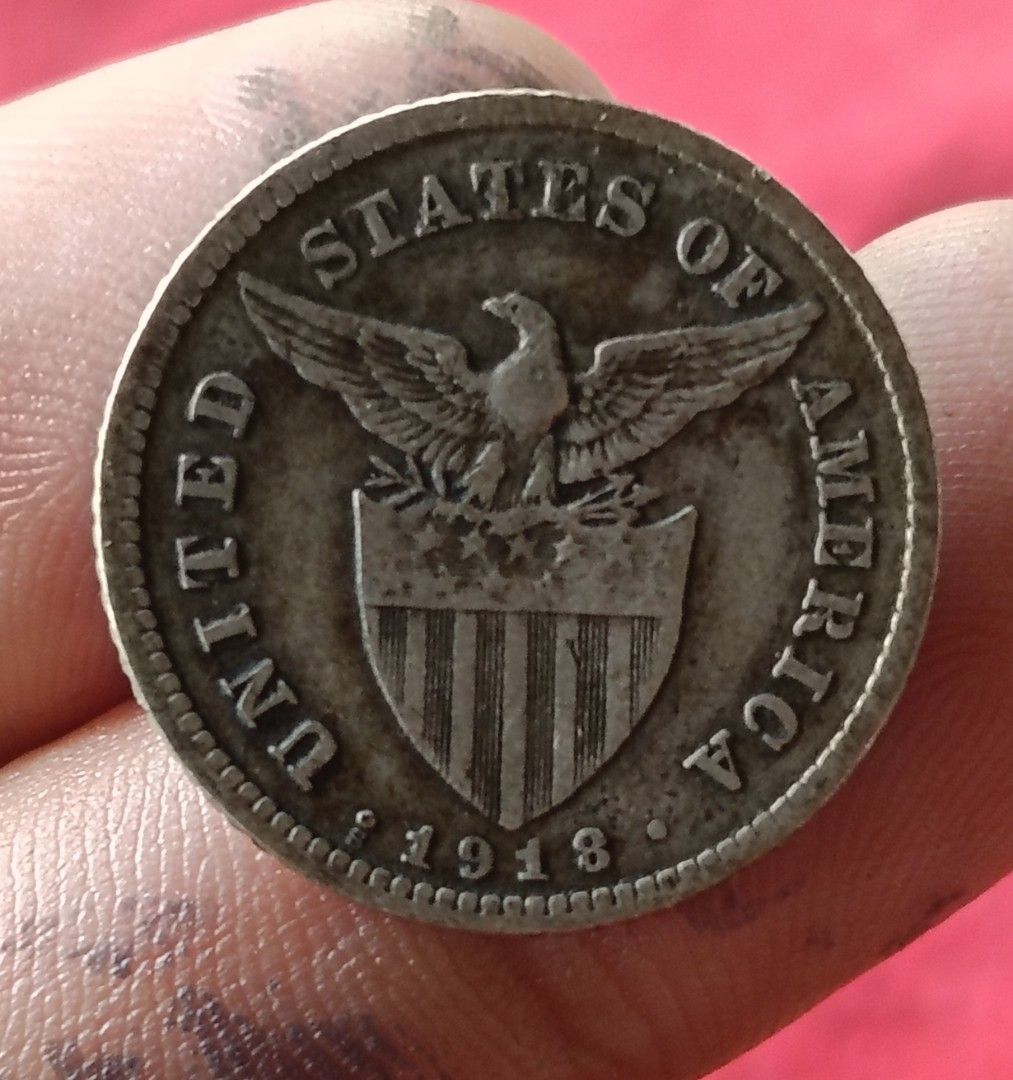 US Philippines 1918 Twenty Centavos Silver Coin (Category: Currency) located in Batangas. Submitted by swiftstone.96924b (Listing ID 1465002468, Image 1). Description: silver coin - Vintage 1918 Twenty Centavos Filipinas coin - Features US eagle and shield on the obverse - Reverse shows standing figure and iconic volcano - Genuine antique with natural patina and age-appropriate wear - Ideal piece for numismatists and Philippine history collectors