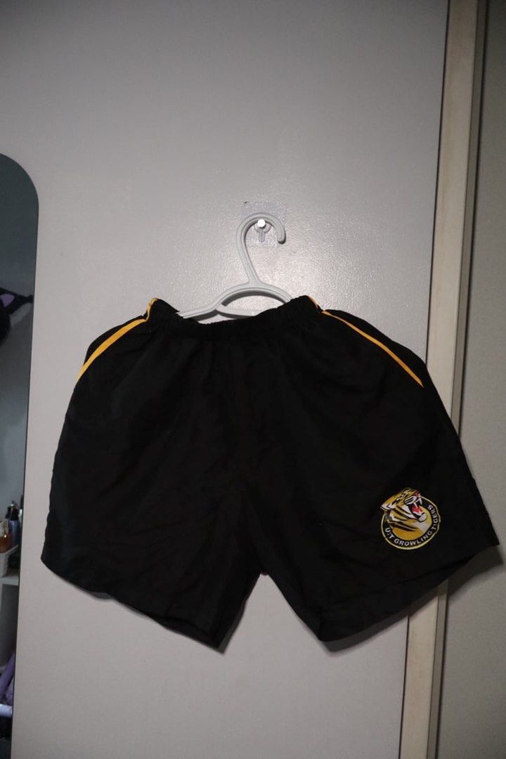 UST Table Tennis shorts (Category: Activewear) located in Manila. Submitted by leivic (Listing ID 1465061097, Image 1). Description: - Color: Black with yellow side piping - Team: Official UST Growling Tigers logo on the left leg - Fit: Comfortable elastic waistband - Material: Lightweight and easy to move in.
