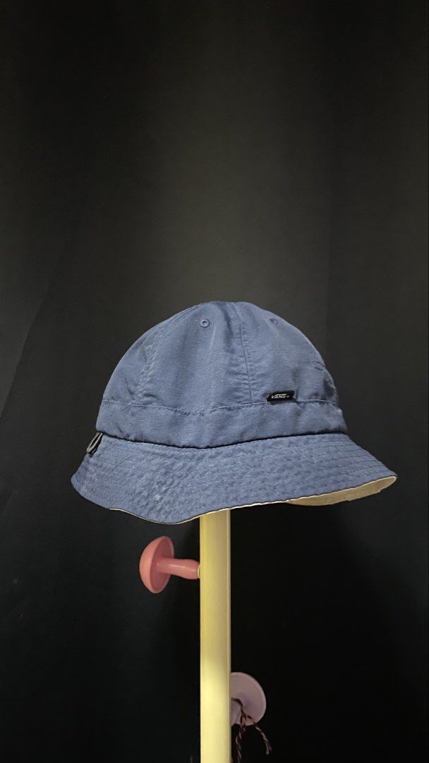 Vans Blue Bucket Hat with Triangle Graphic (Category: Caps & Hats) located in Calamba. Submitted by jonny.1598 (Listing ID 1465114553, Image 1). Description: - Brand: Vans - Color: Navy blue with cream inner lining - Material: Nylon and cotton blend - Design: Small triangle pennant graphic on the side with a woven brand label near the brim - Origin: Made in Bangladesh - Style: Casual streetwear, perfect for everyday sunny days out -sf -issue sa s