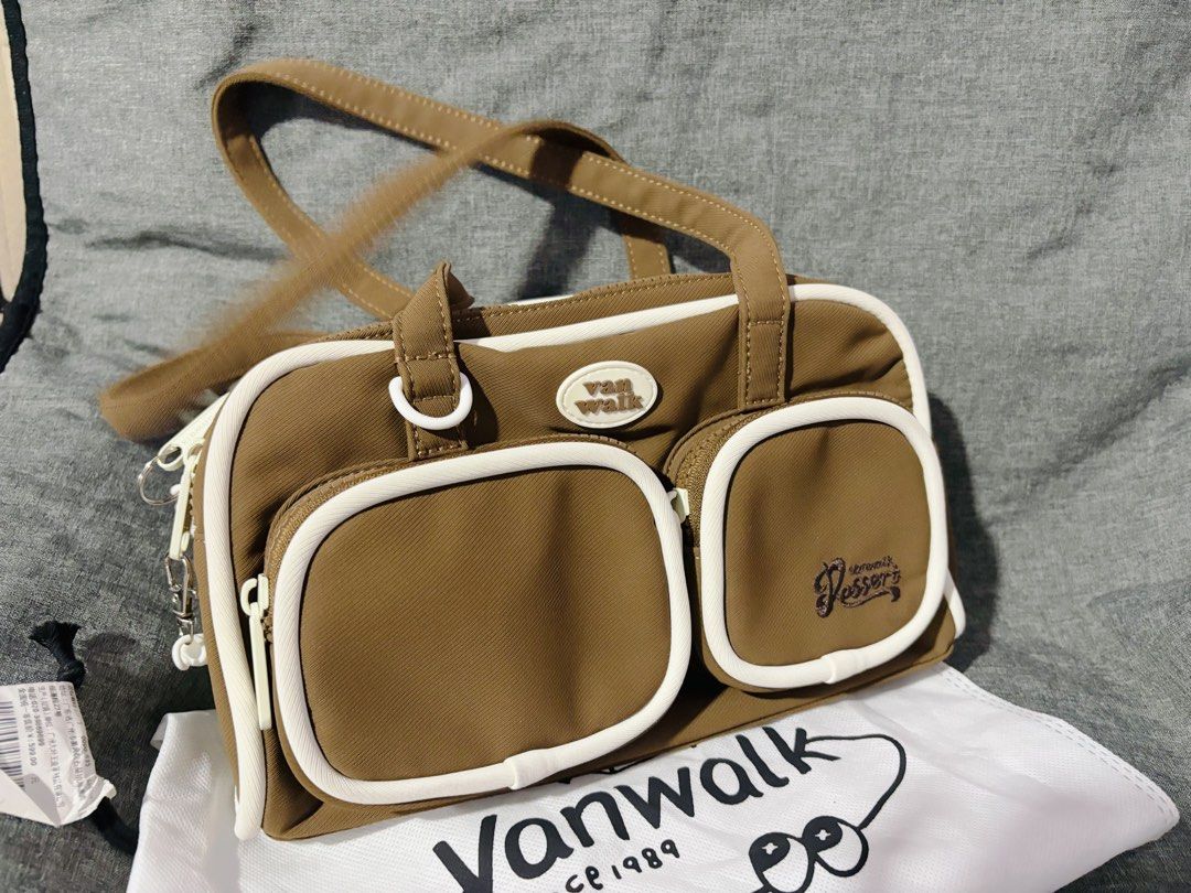 Vanwalk Brown Shoulder Bag (Category: Shoulder Bags) located in Quezon City. Submitted by mjmic (Listing ID 1465022350, Image 1). Description: - Stylish brown design with contrast white piping - Dual-zip main compartment with cream inner lining - Ample storage with 2 front pockets, back zipper pocket, and interior zipper pocket - Features authentic Vanwalk Yummy logo patch.