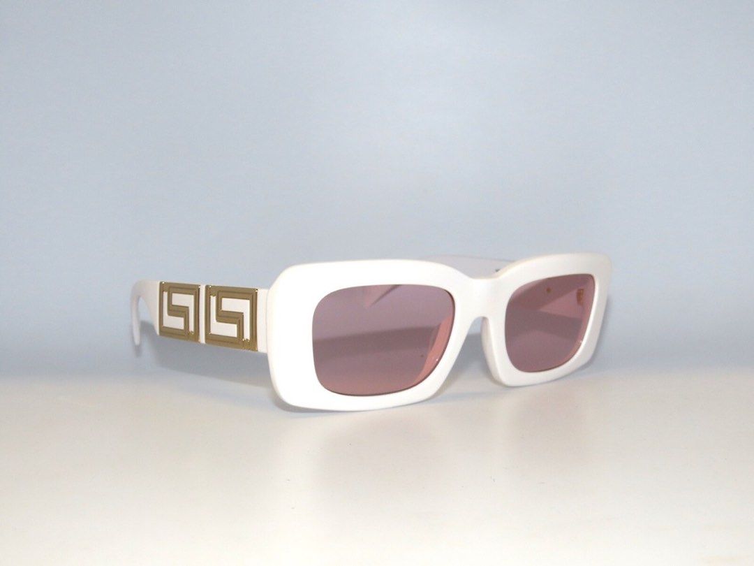 Versace Endless Greca Sunglasses (UNISEX) (Category: Sunglasses & Eyewear) located in Manila. Submitted by willywonkawinner (Listing ID 1465030747, Image 1). Description: Versace square-shaped sunglasses feature acetate frames and metal Greca openwork hardware at the temples. Details and care below: Greca hardware Made in Italy Frame color: White Temple color: White Lens color: Pink Tip on Size or Measure Eye size: 54 mm Bridge: 21 mm Temple: 140