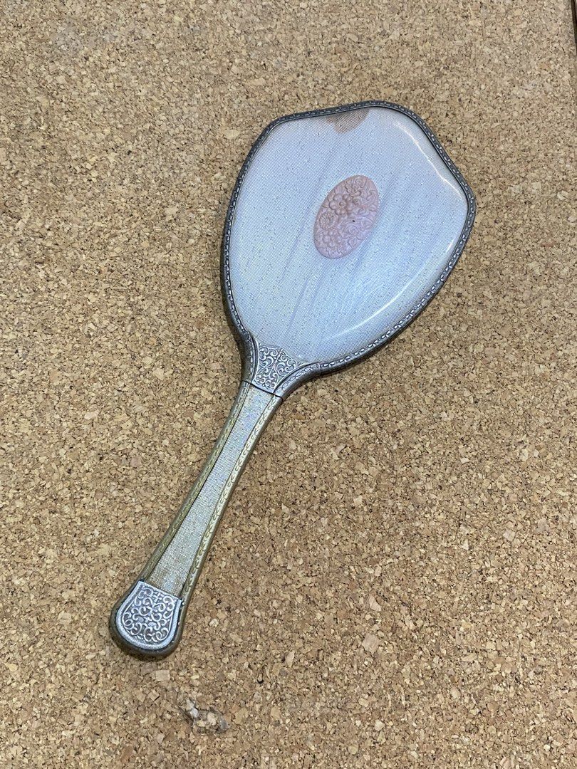 Vintage 1960s Vanity Hand Mirror (Category: Mirrors) located in Calamba. Submitted by chebvintagedepot (Listing ID 1465028129, Image 1). Description: [B29-03] This Pola Cosmetics hand mirror is a Japanes promotional novelty item from the 1960s–1970s. It has an ornate silver-toned frame with gold accents and a pink floral cameo-style center detail. The decorative design gives it a distinctive retro look, suitable for display, collecting, or use as