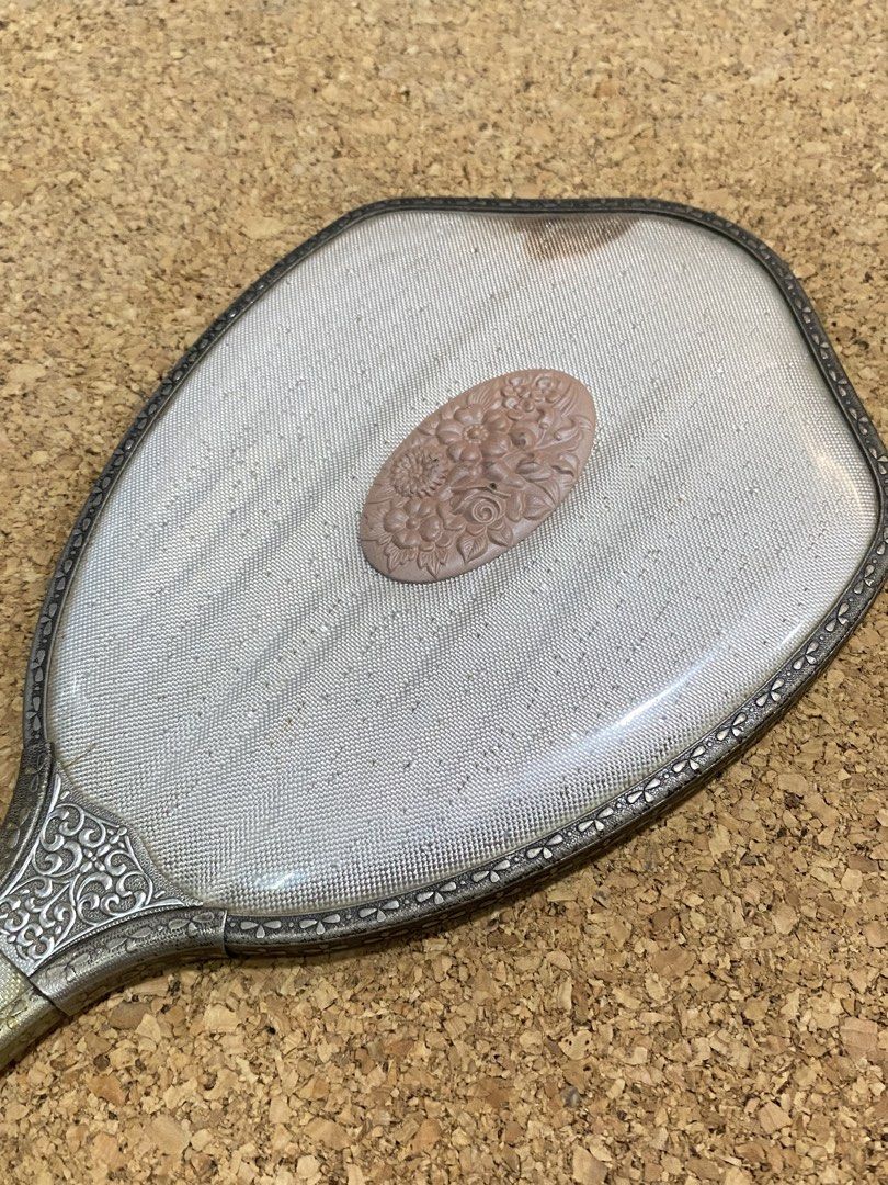 Vintage 1960s Vanity Hand Mirror (Category: Mirrors) located in Calamba. Submitted by chebvintagedepot (Listing ID 1465028129, Image 2). Description: [B29-03] This Pola Cosmetics hand mirror is a Japanes promotional novelty item from the 1960s–1970s. It has an ornate silver-toned frame with gold accents and a pink floral cameo-style center detail. The decorative design gives it a distinctive retro look, suitable for display, collecting, or use as
