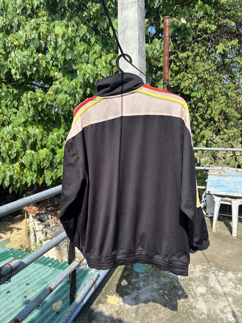 Vintage Adidas Black Track Jacket Size M (Category: Coats, Jackets and Outerwear) located in Cebu City. Submitted by purephoenix-2e10a3 (Listing ID 1464972971, Image 2). Description: - Brand: Adidas - Style: Black track jacket with beige chest and shoulder panels - Details: Colorful stripes on sleeves, red embroidered Adidas logo - Hardware: Custom metal zipper pull shaped like the Adidas trefoil logo - Size: Medium - Features: Full zip closure, 