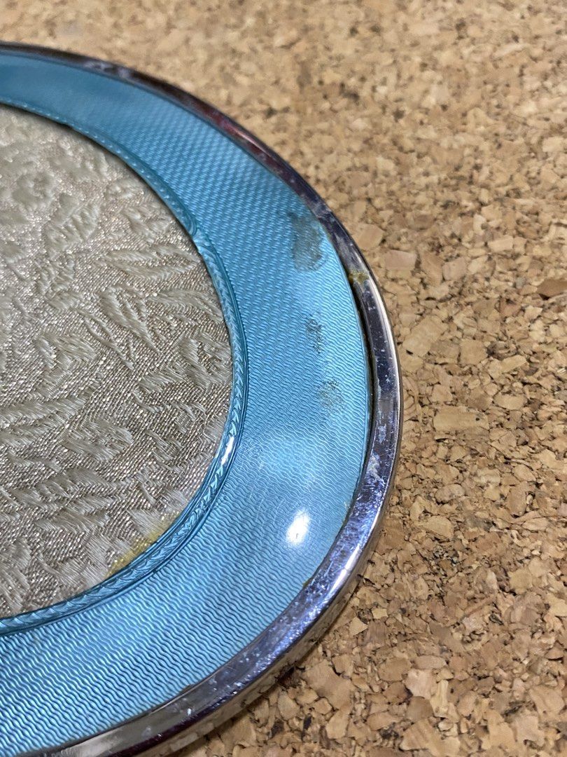 Vintage Art Deco Vanity Hand Mirror (Category: Mirrors) located in Calamba. Submitted by chebvintagedepot (Listing ID 1465033431, Image 3). Description: [B29-04] This vintage Art Deco-style hand mirror has an oval shape with an ornate handle and a guilloché finish. The silver-tone metal frame is complemented by a decorative floral-patterned back panel with a protective cover. The combination gives the mirror a classic vintage vanity look inspired