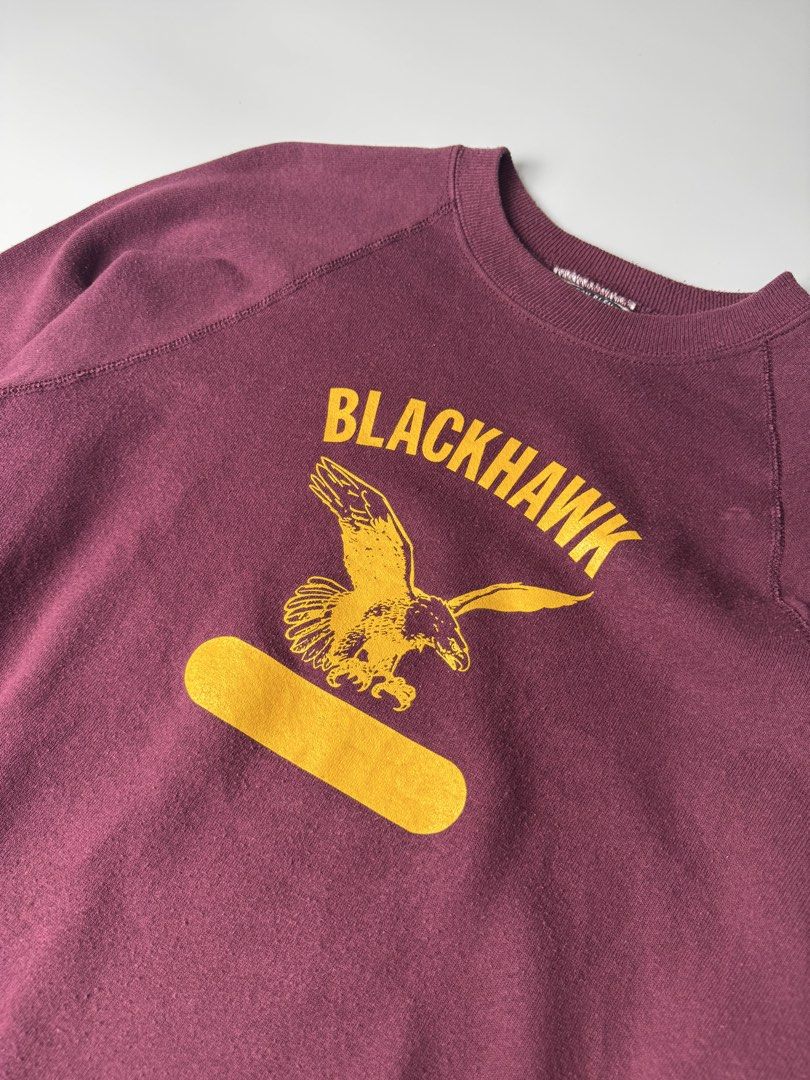 Vintage Maroon Blackhawk Eagle Print Crewneck Sweatshirt (Category: Coats, Jackets and Outerwear) located in Cavite. Submitted by dracokidstuff (Listing ID 1465085151, Image 2). Description: - Color: Maroon with yellow graphic print - Design: Flying eagle and "Blackhawk" lettering on the chest - Fit: Raglan sleeves, ribbed cuffs and hem - Measurements: Pit to pit ~23.5", Total length ~29", Sleeve length ~29" from collar - Material: Cotton blend -