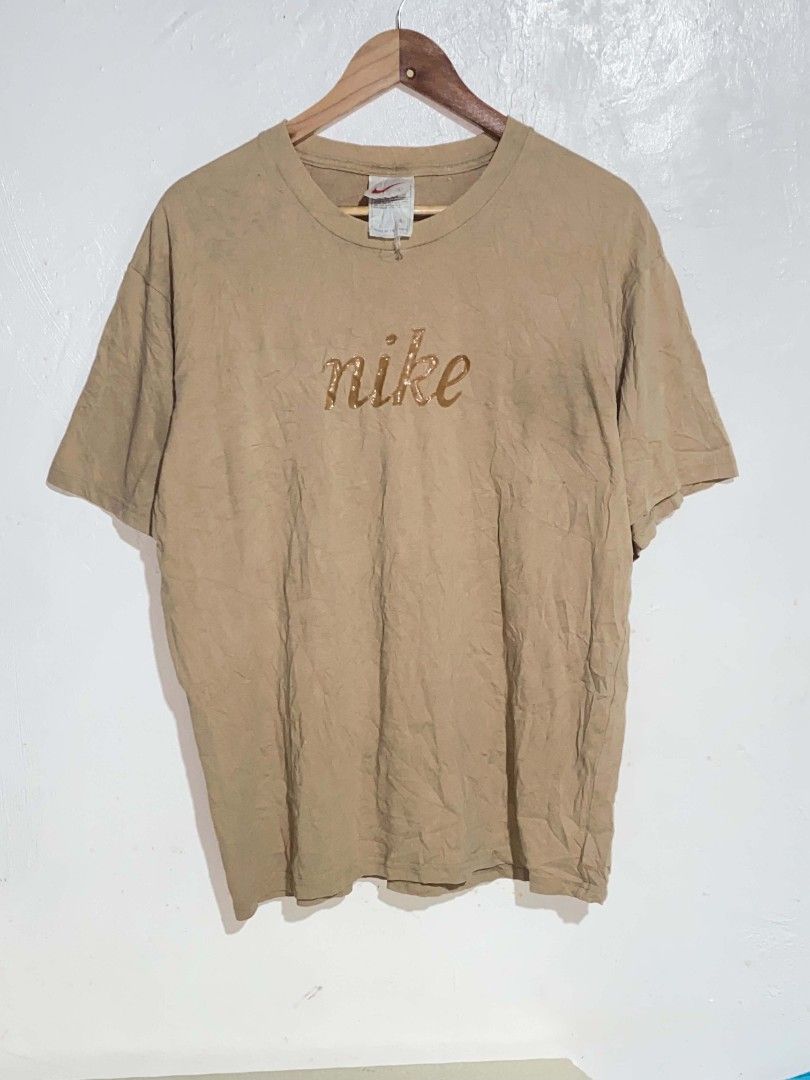 Vintage Nike Script Logo Brown T-Shirt (Category: Tshirts & Polo Shirts ) located in Maasin. Submitted by trippythirftyyy (Listing ID 1465091998, Image 1). Description: - Brand: Nike - Color: Tan Brown - Design: Script logo across the chest - Size: Large - Fit: Boxy vintage fit - Material: 100% cotton - Era: Vintage (Made in Hong Kong tag) - Condition: Great classic streetwear piece, easy to style -excellent condition -no issue, need wash only.
