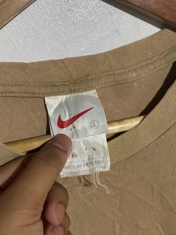 Vintage Nike Script Logo Brown T-Shirt (Category: Tshirts & Polo Shirts ) located in Maasin. Submitted by trippythirftyyy (Listing ID 1465091998, Image 3). Description: - Brand: Nike - Color: Tan Brown - Design: Script logo across the chest - Size: Large - Fit: Boxy vintage fit - Material: 100% cotton - Era: Vintage (Made in Hong Kong tag) - Condition: Great classic streetwear piece, easy to style -excellent condition -no issue, need wash only.